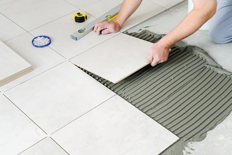 Contractor Installing Ceramic Tile Flooring