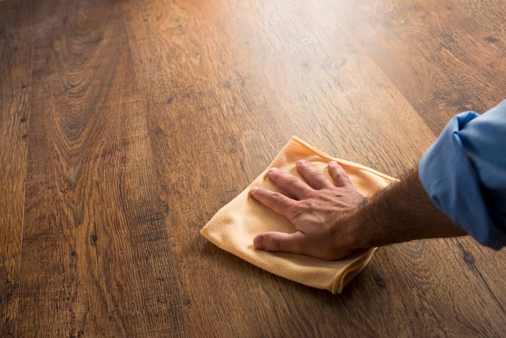 Man Cleaning Hardwood Floors with a Cloth